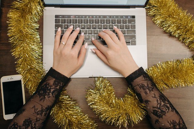 woman hands typing on laptop