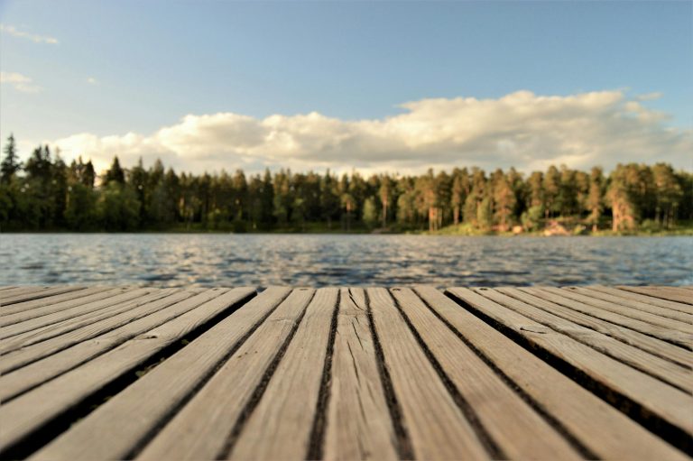 photo of a deck overlooking the water and trees
